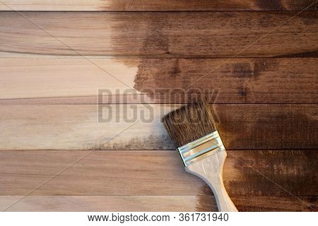 Wooden Boards Half Covered With Stain Top View. A Brush With A Wooden Handle And Natural Bristles Ag