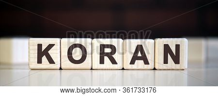 Koran - Holy Book, Text On Wooden Cubes On Darkbackground Surrounded By Other Cubes