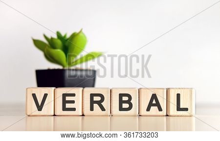 Verbal - Text On Wooden Cubes And Flower In A Pot In The Background
