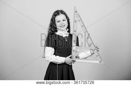 Smart And Clever Concept. Girl With Big Ruler. School Student Study Geometry. Sizing And Measuring. 