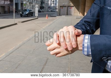 Businessman In A Blue Suit Using Small Portable Antibacterial Sanitizer Applying Antiseptic For Wash