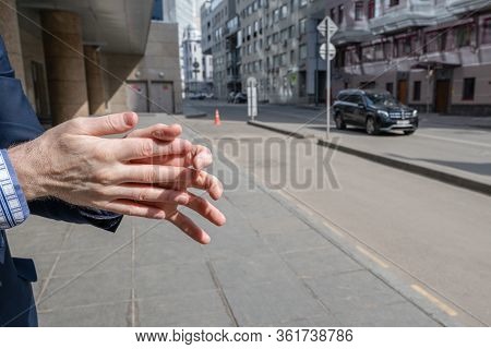 Businessman In A Blue Suit Using Small Portable Antibacterial Sanitizer Applying Antiseptic For Wash