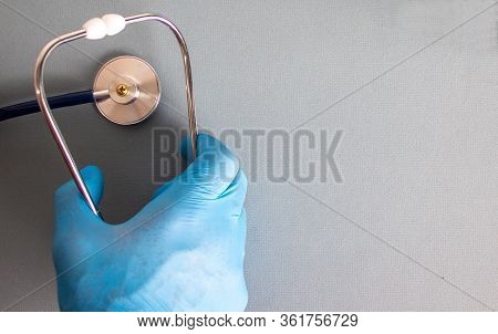 Hand In Blue Glove, Stethoscope. Empty Space For Your Text.