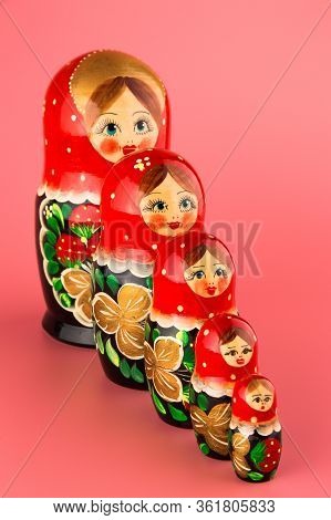 Russian Folk Wooden Doll On A Pink Background