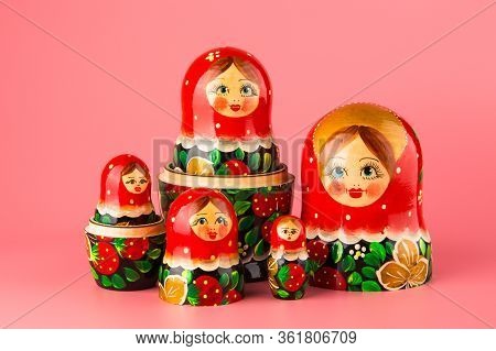 Russian Folk Wooden Doll On A Pink Background