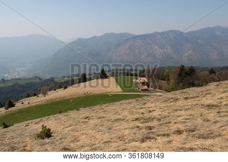 The View Of Rural Contryside In Mountains. Agricultural Fields On Hills With Mountains On Background