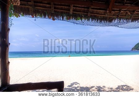 A Single Bamboo Chair In The Middle Of An Empty Exotic Beach. View From The Bungalow To The Sin Htau