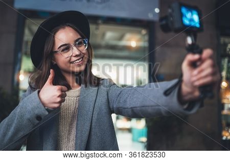 Female Vlogger Recording With Digital Camera Showing Ok Or Like. Smiling Woman Taking Selfie Video O