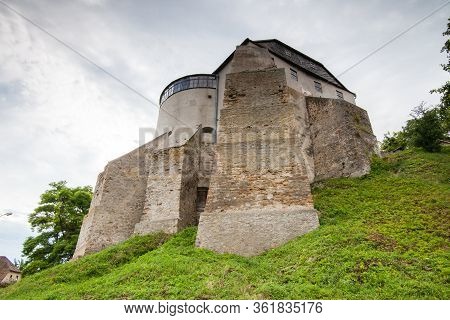The Round Tower Of The Ostrog Castle In Western Ukraine. Bottom View Of The Walls, Rivne Region, Ukr