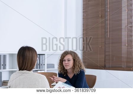Professional Counselor And Woman Suffering From Depression During Therapy