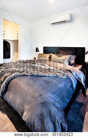 Dark And Thick Bed Sheet Of A Modern Room Including Fur Duvets