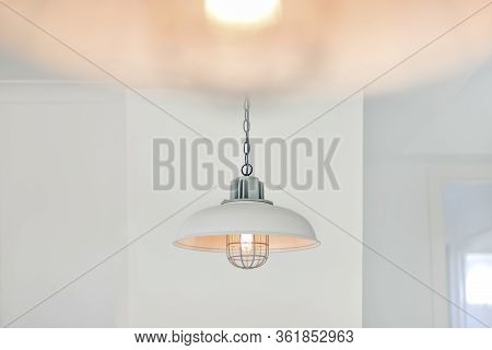 Light Bulb Flashing And Hanging With A Cover With A White Wall Of Luxury House