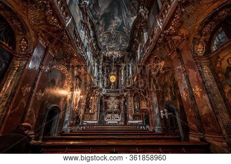Feb 2, 2020 - Munich, Germany: Prayer In Late Baroque Church Asamkirche With Lights On Before Sunset