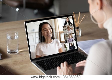Asian Woman And Diverse Colleagues Taking Part In Group Videocall