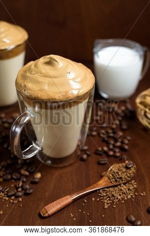 Cold Dalgon Coffee In Clear Glasses On A Dark Wooden Background. Foam From Sugar And Instant Coffee