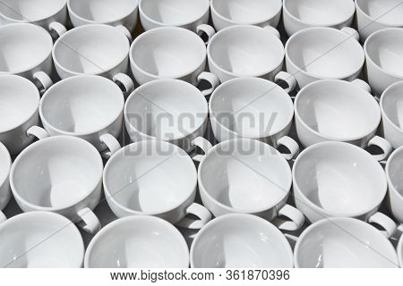 Top View On Many Stacked In Rows Of Empty Clean White Cups For Tea Or Coffee. Close-up. Background.