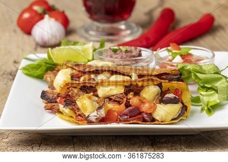 Overview Of Baked Tacos With Salsa On Wood