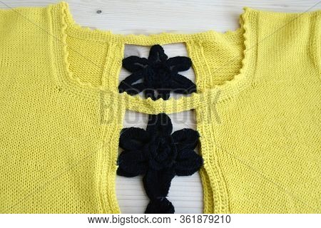 Knitted Sweater, Fragment. Knitted Fabric Structure.  Sweater Neckline. The Edge Of The Product Is C