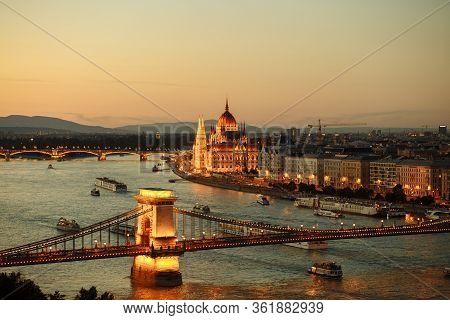 Night View Of The City Of Budapest On The Danube River On Which Ships With Illuminated Bridge And Pa