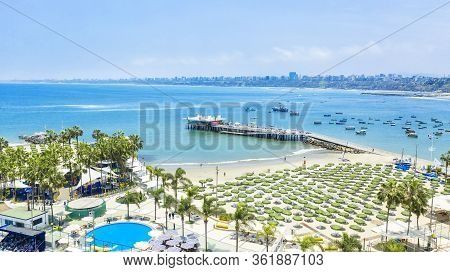 Private Beach Club In The District Of Chorillos With Distant Shore Covered In Air Pollution Haze In 