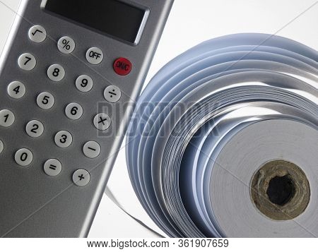 Calculator with adding machine tape, closeup