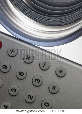 Calculator with adding machine tape, closeup