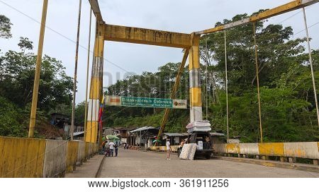 La Hormiga, Putumayo / Colombia - March 8 2020: People Crossing The International Bridge Over The Sa