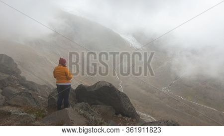 Cayambe, Pichincha / Ecuador - February 24 2020: Alone Young Woman Looking At The Landscape Of The C