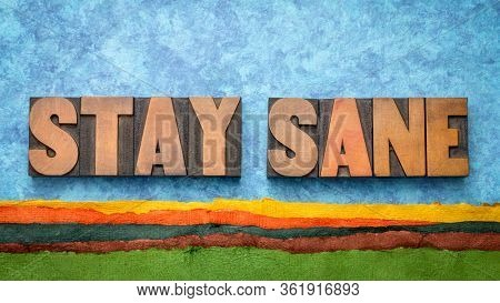 stay sane  - inspirational word abstract in vintage letterpress wood type against abstract paper landscape, positivity, faith and  optimism concept