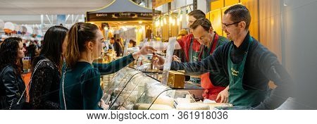 Strasbourg, France - Feb 16, 2020: Seller Offering Cheese To Young Girls At French Wine At The Vigne