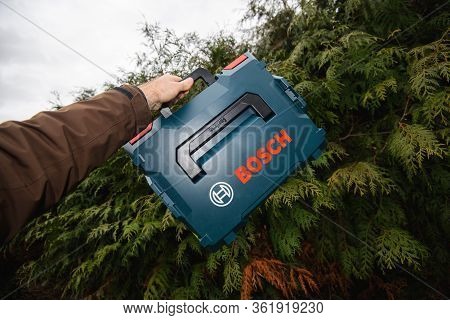 Paris, France - Feb 23, 2019: Pov Man Hand Holding Against Green Background New Box Of Bosch L-boxx 
