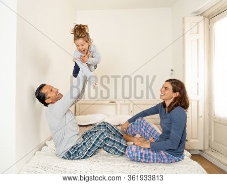 Covid-19 Stay Home Concept. Happy Family, Parents And Little Cute Daughter Having Fun Together