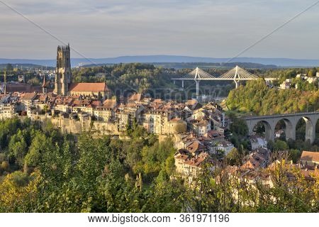Panoramic View Of Cathedral Of St. Nicholas, New Poya And Old Zaehringen Bridge By Night, Fribourg, 