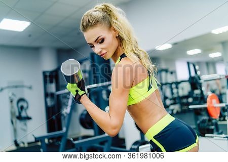 Fit Woman Working Out At The Gym. Athlete And Beauty Doing Workout. Health Life Sport Concept.