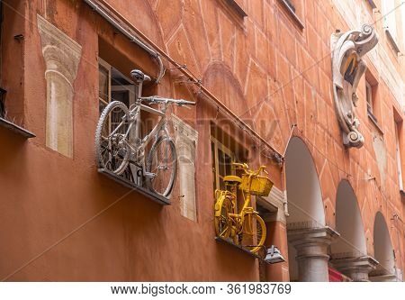 Art Installation Of Two Bicycles On The Wall Of A House In The City Of Savona