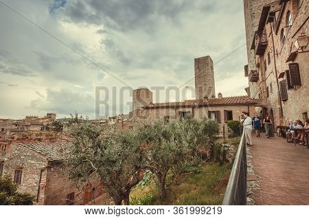 San Giminiano, Italy: People Look On Landscape From High Point Of Ancient Tuscan Town On 19 Septembe