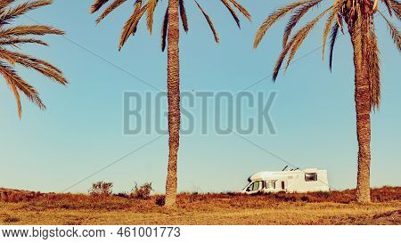 Camper, Recreational Vehicle On Mediterranean Coast With Palm Trees In Spain. Camping On Percheles B