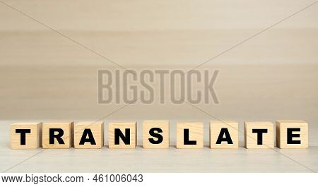 Word Translate Made Of Wooden Cubes With Letters On Table. Space For Text