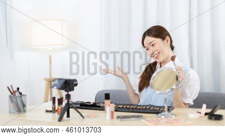 Beautiful women with social media influences are teaching makeup and use cosmetics, In front of the 