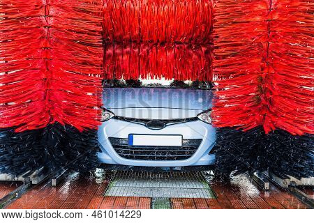 Car Washing Machine. Auto Brush Washer Clean Blue Car On Automatic Carwash Station. Automated Car Wa