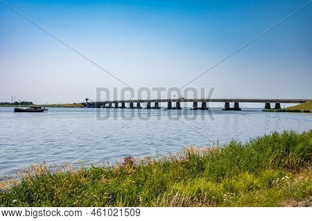 Nagele, Flevoland, The Netherlands - 07 20 2022 - Bridge Over The Ketel Lake With The Green Polder A