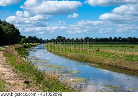 Creek Through Green Wetlands Over Blue Sky At The Oostervoorts Diep National Park, The Netherlands
