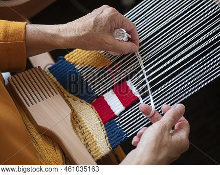 Artisan Is Creating A Bright Tapestry With Lighthouse Using Yarn And Weft Beater, Selective Focus. H