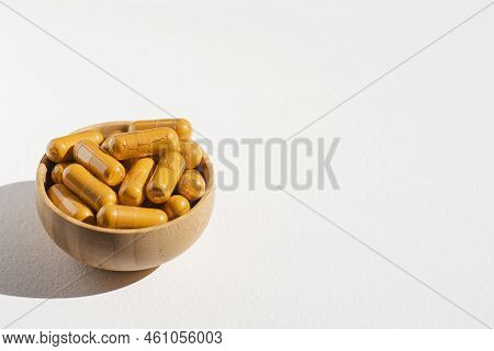Turmeric Plus Black Pepper Extract Gelatin Capsule Close Up In Soft Focus. Herbal Supplement Organic