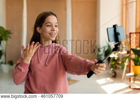 Pretty Famous Teenager Blogger Or Vlogger Streaming From Home, Using Mobile Phone On Tripod And Talk