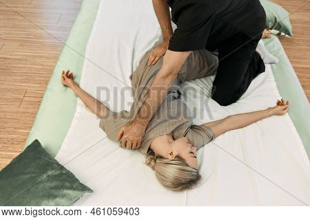 Massage Therapist Doing Massage Using Oriental Techniques Yumeiho For Correcting Posture Of Womans B