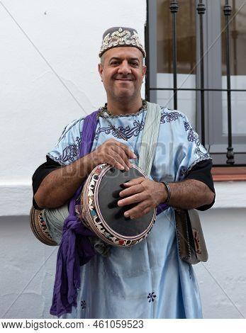 Frigiliana, Malaga, Spain, August 27, 2022: Arab Musician With A Derbake Drum And A Blue Djellaba At