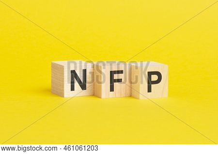 Wooden Blocks With Text Nfp On Yellow Background. Business Concept