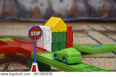 The Car And The Traffic Sign Stop Are Built From The Constructor In The Game Room. A Toy Car Is Park