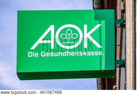 Germany, Dillenburg 2022-07-17: Green Aok Sign Hanging On A Old House Facade. Aok Is A German Health